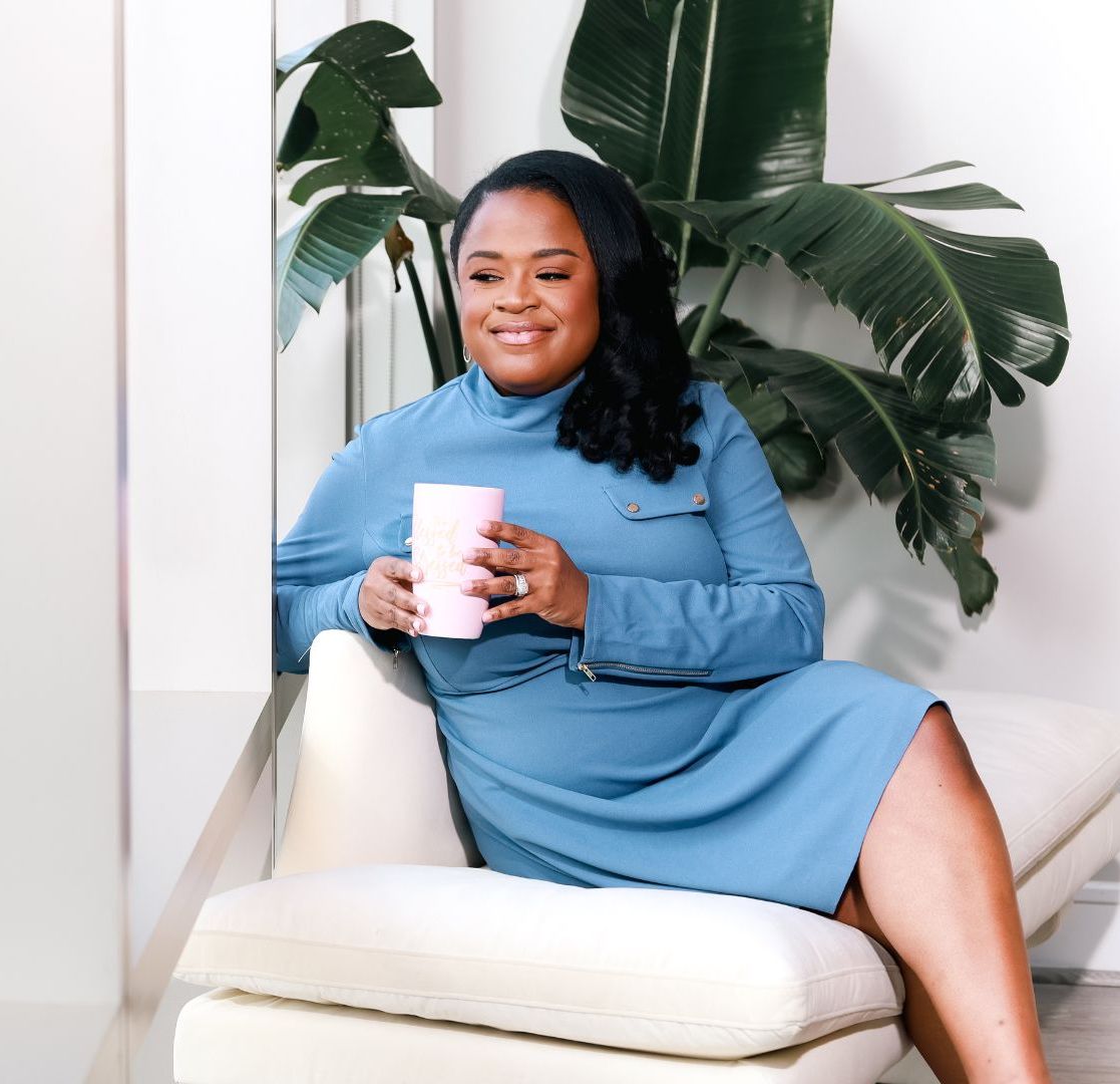 Alicia Perkins seated with a coffee cup