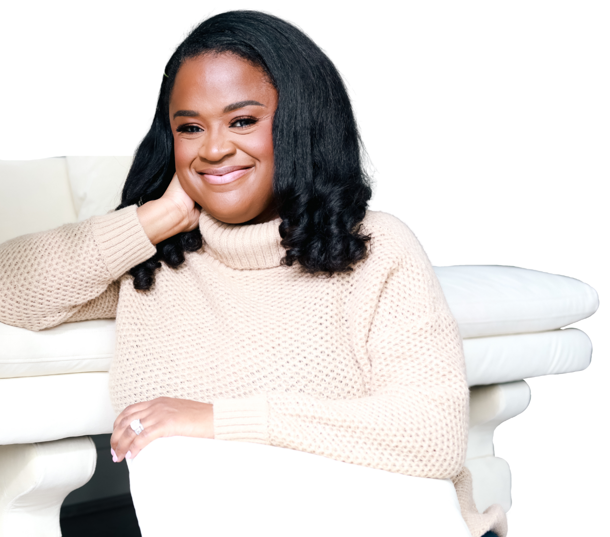 Alicia Perkins seated on a white couch, founder of The Positioning House
